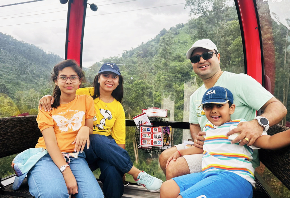 A photo of a family smiling inside the cable car