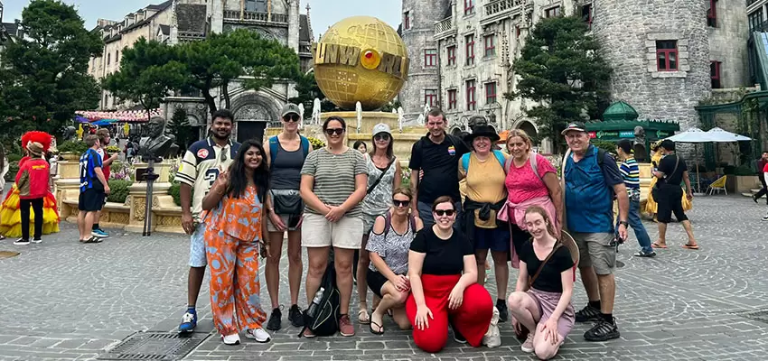 A lively photo of a private group with their guide enjoying an attraction at Bana Hills, capturing the personalized vibe.